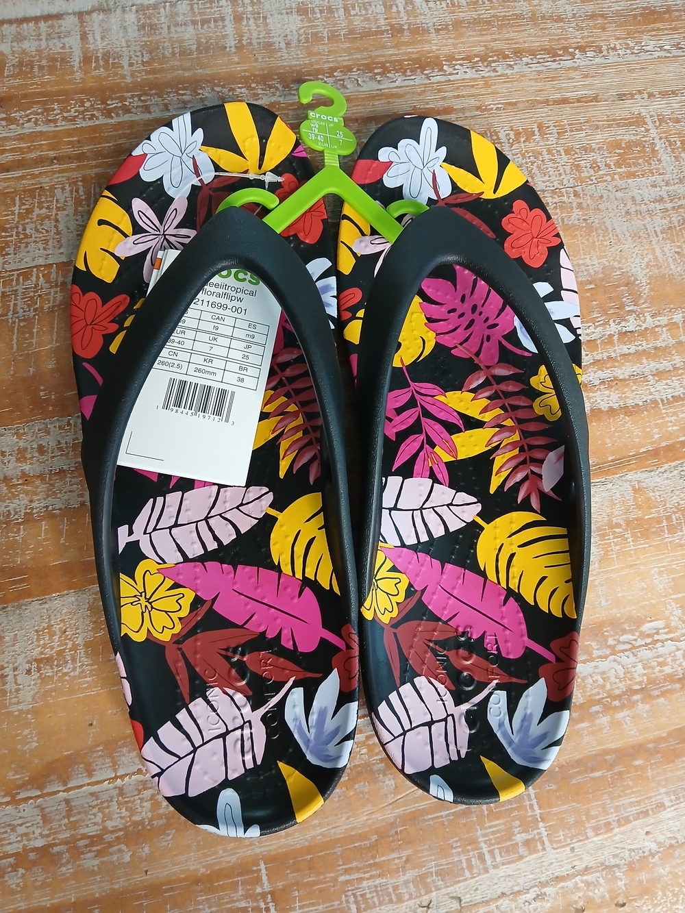 CROCS Women’s Black Tropical Floral Flip Flops with Pink & Yellow Accents